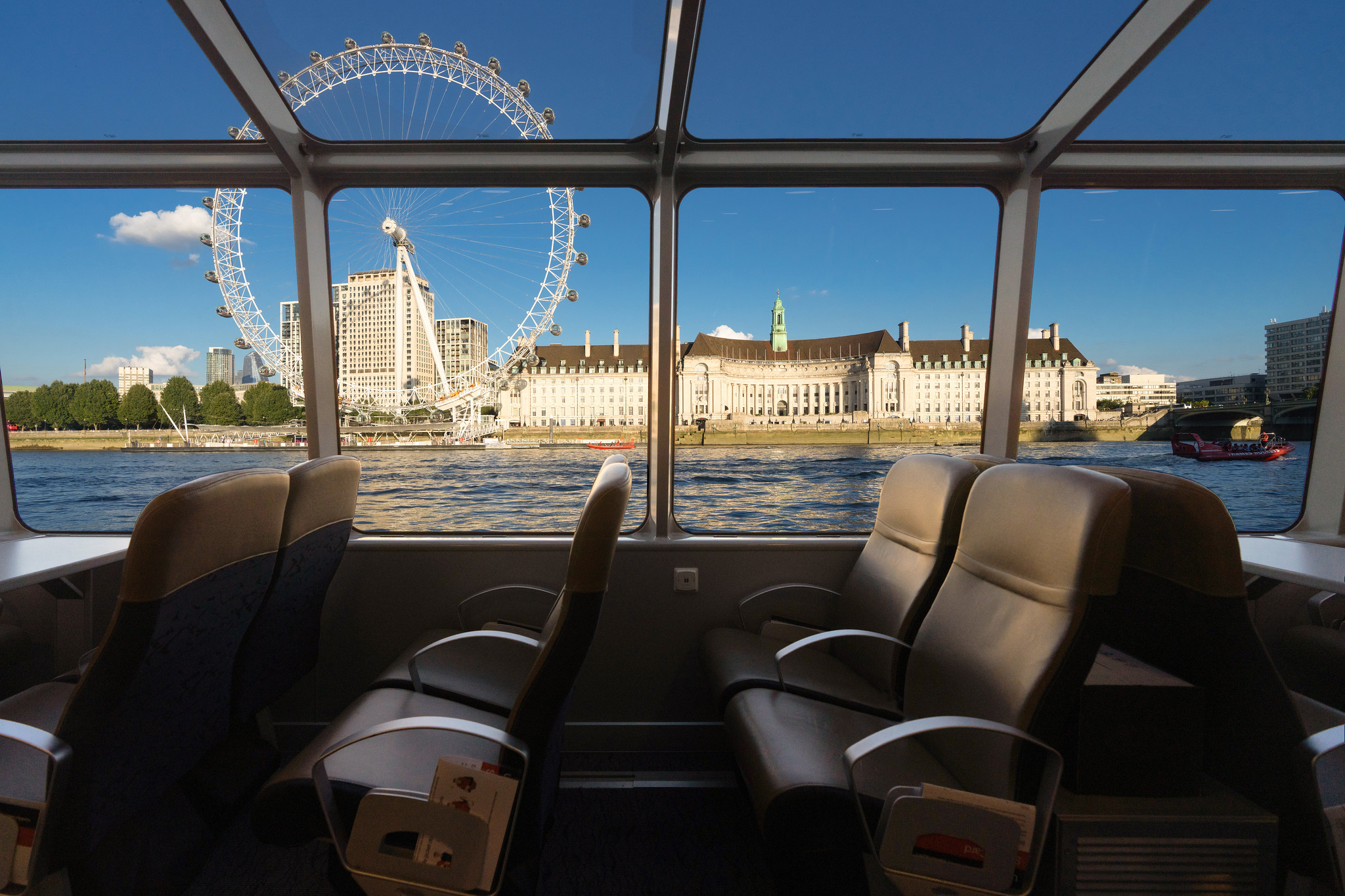 London Eye with blues skies from inside the boat