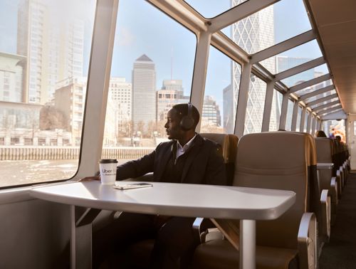Commuter having coffee on board the River Bus